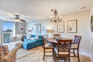 a living room with a blue couch and a table at Phoenix 7 215 in Orange Beach
