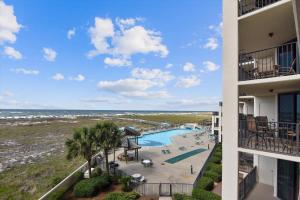 a view of the pool and beach from the balcony of a building at Phoenix 7 215 in Orange Beach