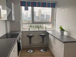 a kitchen with a window with a view of a city at Private Bedroom with an Office Desk in a shared 2 bedroom flat in London