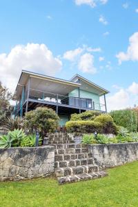 a house with a stone staircase in front of it at Beachside at Margaret River - Spacious Family Beach House in Exclusive Prevelly Location in Prevelly