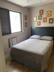 a bedroom with a large bed with a window at Apartamento 4 quartos Beira Mar Balneário Camboriú in Balneário Camboriú