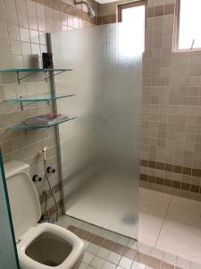 a bathroom with a toilet and a shower stall at Apartamento 4 quartos Beira Mar Balneário Camboriú in Balneário Camboriú +16 photos