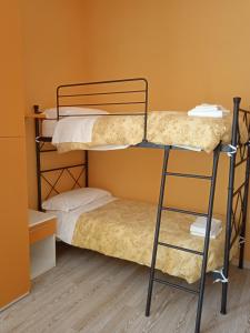 a couple of bunk beds in a room at Ostello La Sosta in Contrada Anselmi