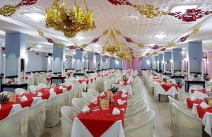 a banquet hall with red and white tables and chairs at Hotel Parco Dei Principi in Scalea +90 photos