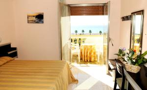 a bedroom with a bed and a view of the ocean at Hotel Parco Dei Principi in Scalea