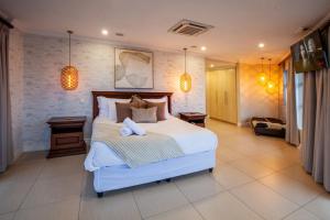 a bedroom with a large bed with two pillows at Stay at The Point - Peaceful Plentiful Penthouse in Durban