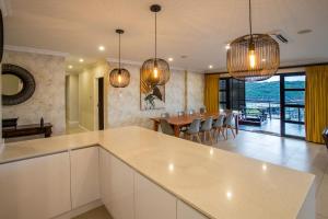 a kitchen and dining room with a table and chairs at Stay at The Point - Peaceful Plentiful Penthouse in Durban