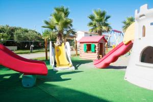 a playground with several slides and a house at Hotel Parco Dei Principi in Scalea
