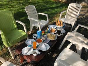 a tray of food on a table between two chairs at Villa Lagoonedge in Hikkaduwa