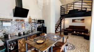a kitchen with a table and a living room at La Casetta in Cursi