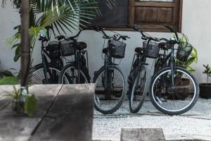three bikes parked in front of a building at Chill Kanil in Tulum