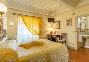 a bedroom with a large bed and a sink at Sotto il Sole di Cortona in Cortona
