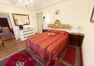 a bedroom with a bed and a dresser and a mirror at Sotto il Sole di Cortona in Cortona