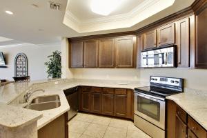 a large kitchen with wooden cabinets and a sink at The Oasis at Orange Beach Unit 2114 (formerly Phoenix West II) in Orange Beach