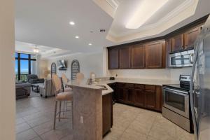 a kitchen with wooden cabinets and a counter top at The Oasis at Orange Beach Unit 2114 (formerly Phoenix West II) in Orange Beach