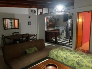 a living room with a couch and a kitchen at Hostal Casaluna San Andres in San Andrés