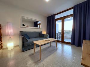 a living room with a blue couch and a table at Tamarán 309 in Playa del Ingles +20 photos
