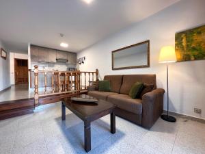 a living room with a couch and a coffee table at Tamarán 311 in Playa del Ingles