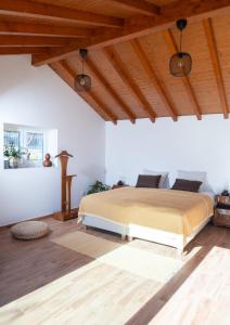 a bedroom with a bed and a wooden ceiling at Family Room - Quinta do Mirante in Castelo de Paiva
