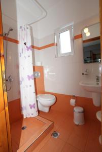 a bathroom with a toilet and a sink at Ilias Studios in Patitiri