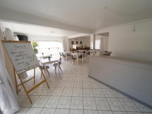 a kitchen with a counter and a table with chairs at Nacional Park Hotel Lages in Lages