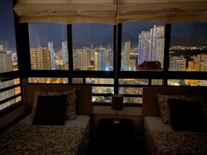 a room with two beds and a view of a city at Benidormflats in Benidorm