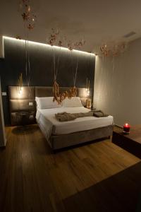 a bedroom with a large bed with lights on it at B&B Villa Grace in Bari