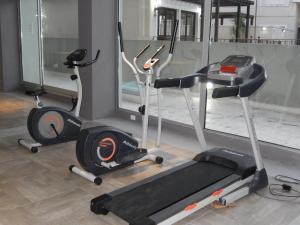 a gym with two exercise bikes and a treadmill at Solares de Araus 406 in Colonia del Sacramento