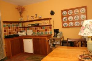 a kitchen with a sink and plates on the wall at Spirit Tree Inn B&B in Patagonia