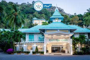 
a building with a clock on the front of it at Krabi Tipa Resort - SHA EXTRA PLUS in Ao Nang Beach

