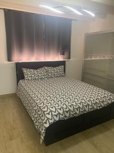a bedroom with a large bed with a black headboard at Oasi verde in Aosta