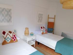 two beds in a room with white walls at Beach Front Las Burras in San Agustin