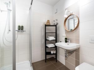 a white bathroom with a sink and a shower at Limehome Magdeburg Breiter Weg in Magdeburg +42 photos