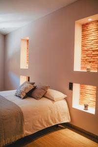 a bedroom with a bed with two pillows on it at Apartamentos Turia Teruel in Teruel
