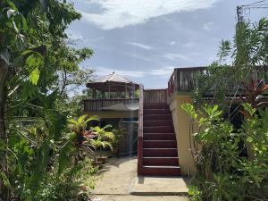 a staircase leading to a house with a gazebo at Can Jam Retreat in Negril
