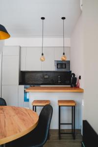 a kitchen with a wooden counter top and a table at Apartamentos Turia Teruel in Teruel