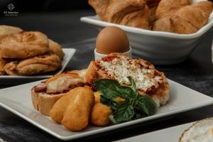 a plate of pastries and an egg on a table at 4- you Family in Metamorfosi