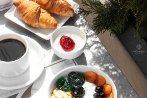 a table topped with plates of food and a cup of coffee at 4- you Family in Metamorfosi