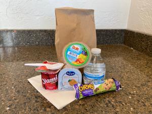 a bag of food and a bottle of water on a counter at Pacific Reef Hotel & Light Show in Gold Beach