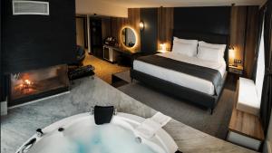 a hotel room with a bed and a bath tub at Oksijen Zone Hotel & Spa - Full Board Plus in Uludag
