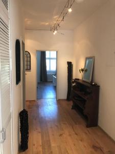 a room with a hallway with a mirror and a piano at Philosophen und Neckarblick Apartment in Heidelberg