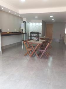 a dining room with a table and chairs on a tile floor at POUSADA DA MAGA in Chapada dos Guimarães