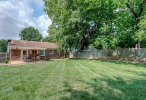 a yard with a house and a fence at Charming 2 BR 1 BA with outdoor patio and grill close to downtown in Lexington