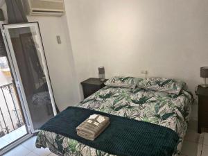 Barbieri Granada Pensión في غرناطة: غرفة نوم بسرير وبطانية خضراء