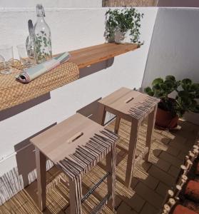 two tables and stools on a patio with plants at Algarve house, sun, terrace, views and barbecue in Silves