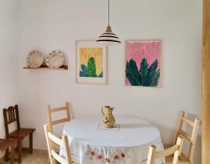 a dining room with a table with a vase on it at Algarve house, sun, terrace, views and barbecue in Silves