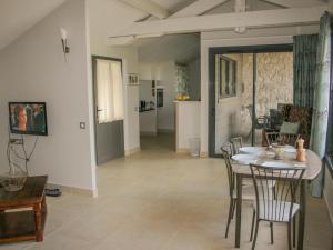 a dining room and living room with a table and chairs at Gite La Séoune in Monjoi +7 photos