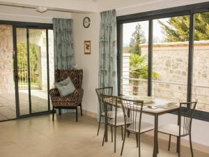 a dining room with a table and chairs and a window at Gite La Séoune in Monjoi