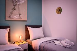 En eller flere senge i et værelse på Apartments Experience Zagreb