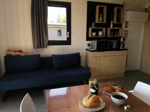 a living room with a blue couch and a table at Auvergne chalets Sancy in Bagnols +30 photos